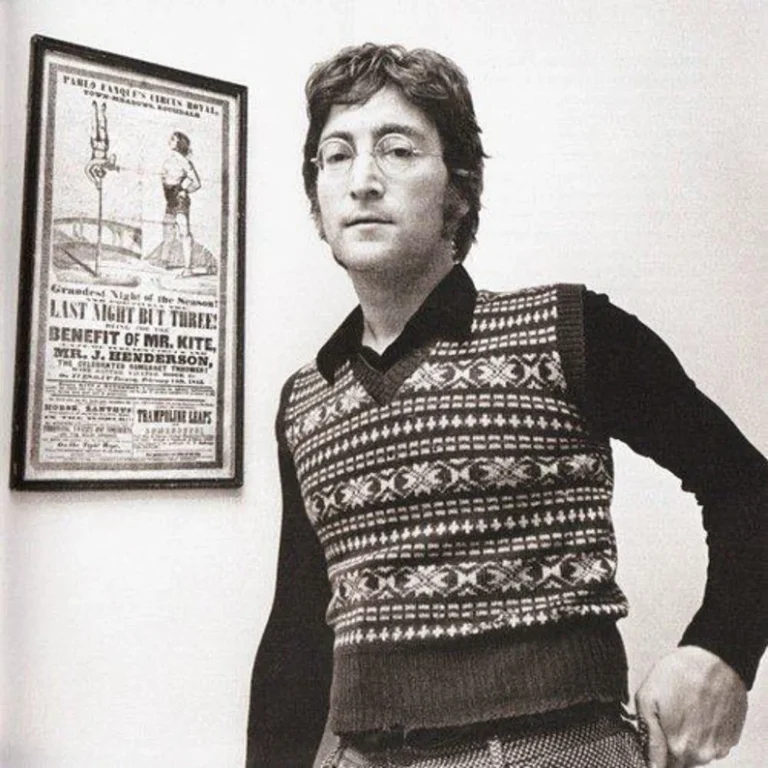 John Lennon standing next to the poster that inspired the 'Being for the Benefit of Mr. Kite' song.